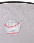 Baseball on a gray cap with visible stitching