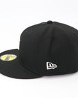 Two black baseball caps with New Era logo on a white background
