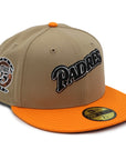 A fitted hat with the San Diego Padres logo, featuring a two-tone kakhi and orange design with a red under visor.