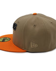 A fitted hat with the San Diego Padres logo, featuring a two-tone kakhi and orange design with a red under visor.