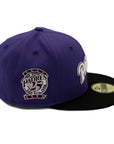 A 2-tone purple and black fitted hat with the San Diego Padres script logo, a 25th Anniversary side patch, and a pink under visor.