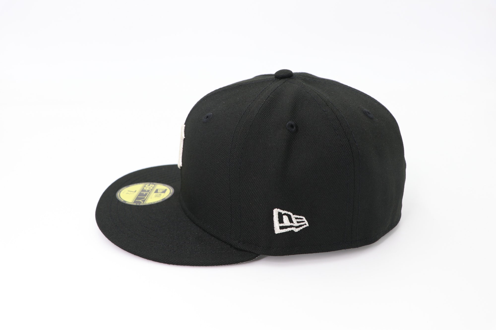 Two black baseball caps with New Era logo on a white background