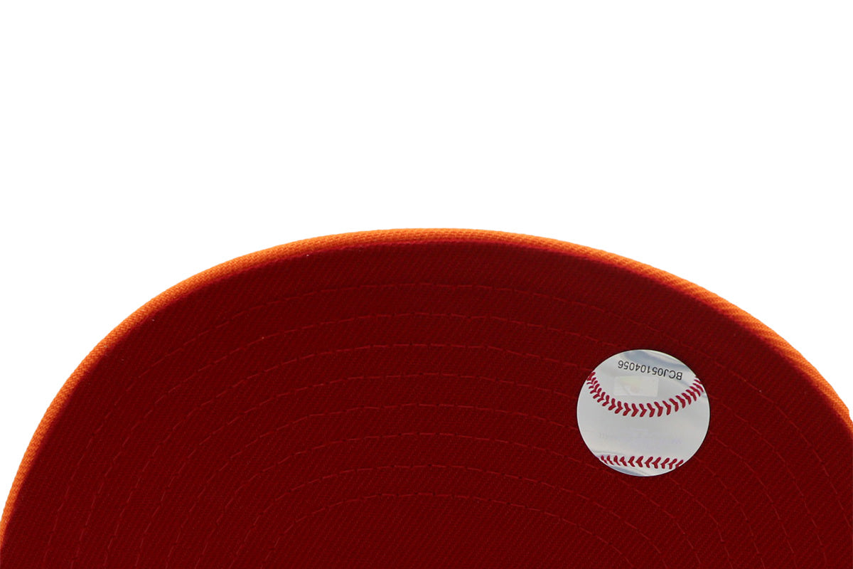 A fitted hat with the San Diego Padres logo, featuring a two-tone kakhi and orange design with a red under visor.