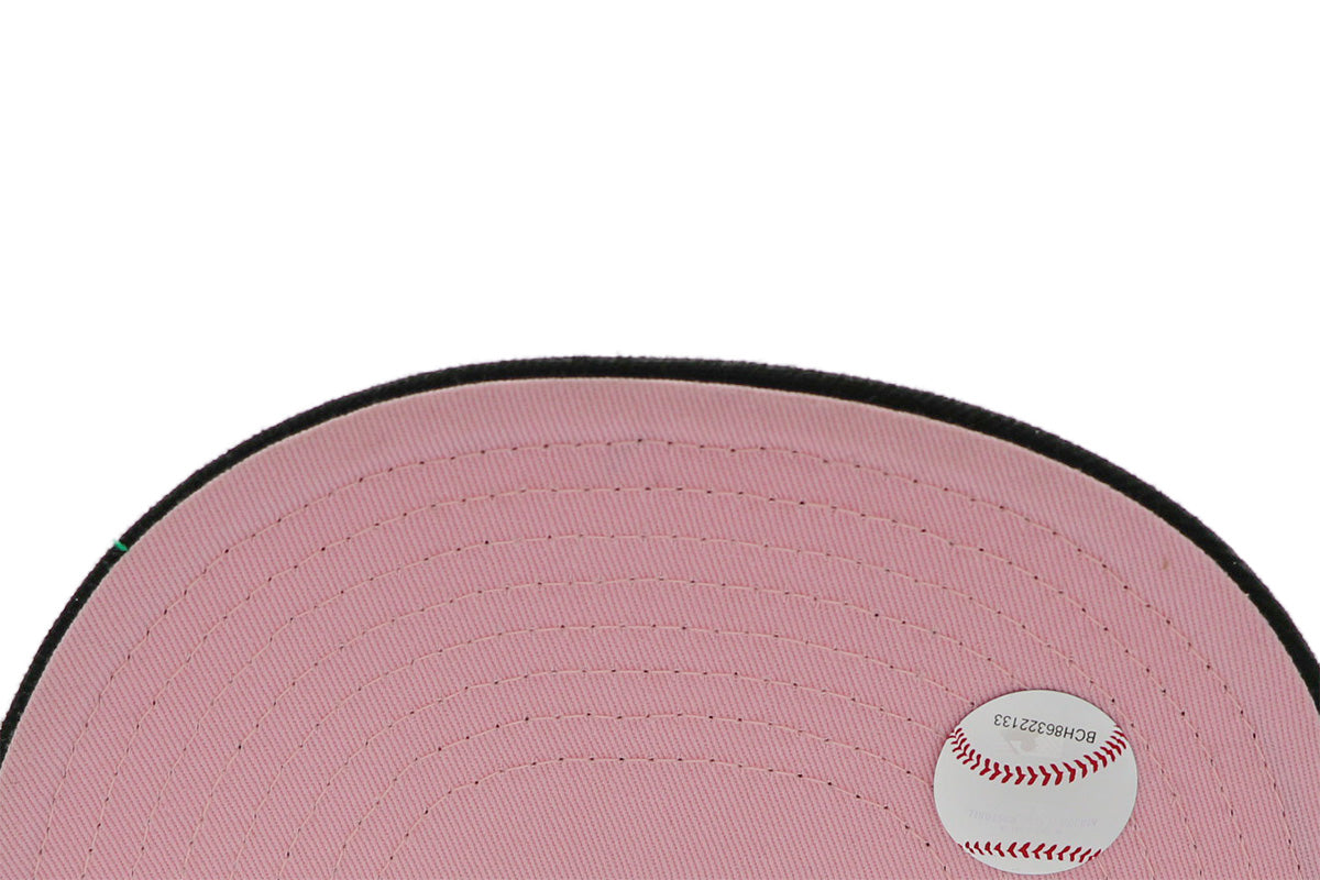 A 2-tone purple and black fitted hat with the San Diego Padres script logo, a 25th Anniversary side patch, and a pink under visor.