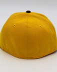 A fitted hat with the San Diego Padres logo, featuring a two-tone brown and yellow design with a green under visor.