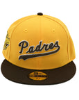 A fitted hat with the San Diego Padres logo, featuring a two-tone brown and yellow design with a green under visor.