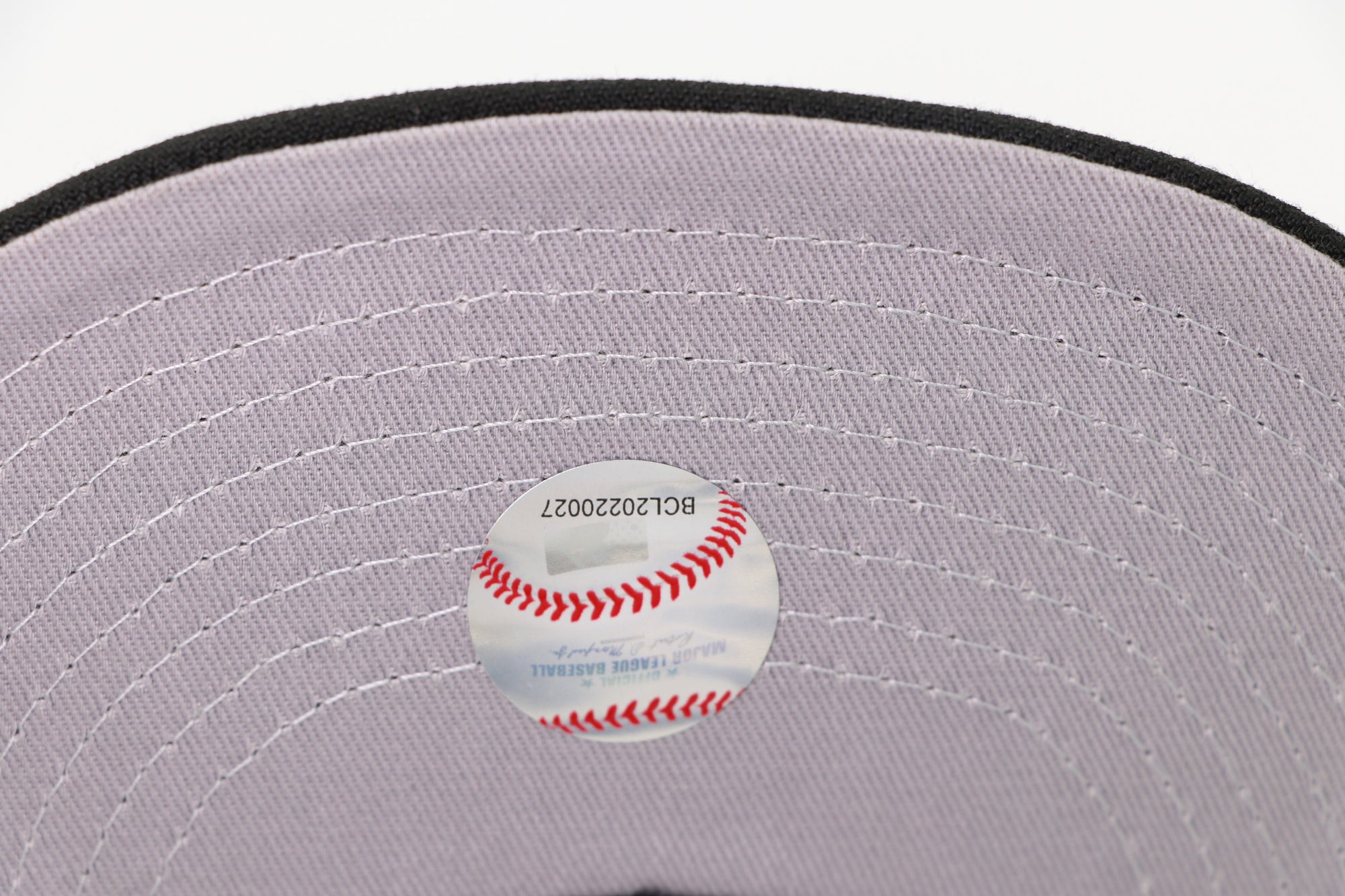 Gray cap with a baseball and brand label on a white background