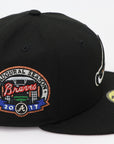 Black baseball cap with embroidered logo on a white background