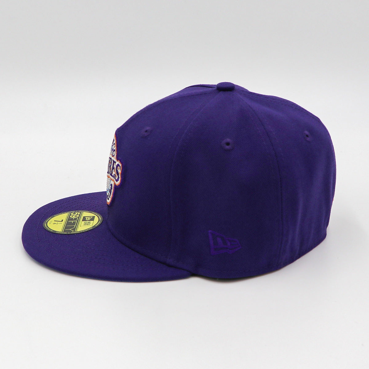 A purple fitted hat with metallic patches featuring the San Diego Padres logo.