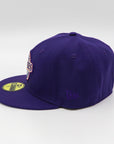 A purple fitted hat with metallic patches featuring the San Diego Padres logo.