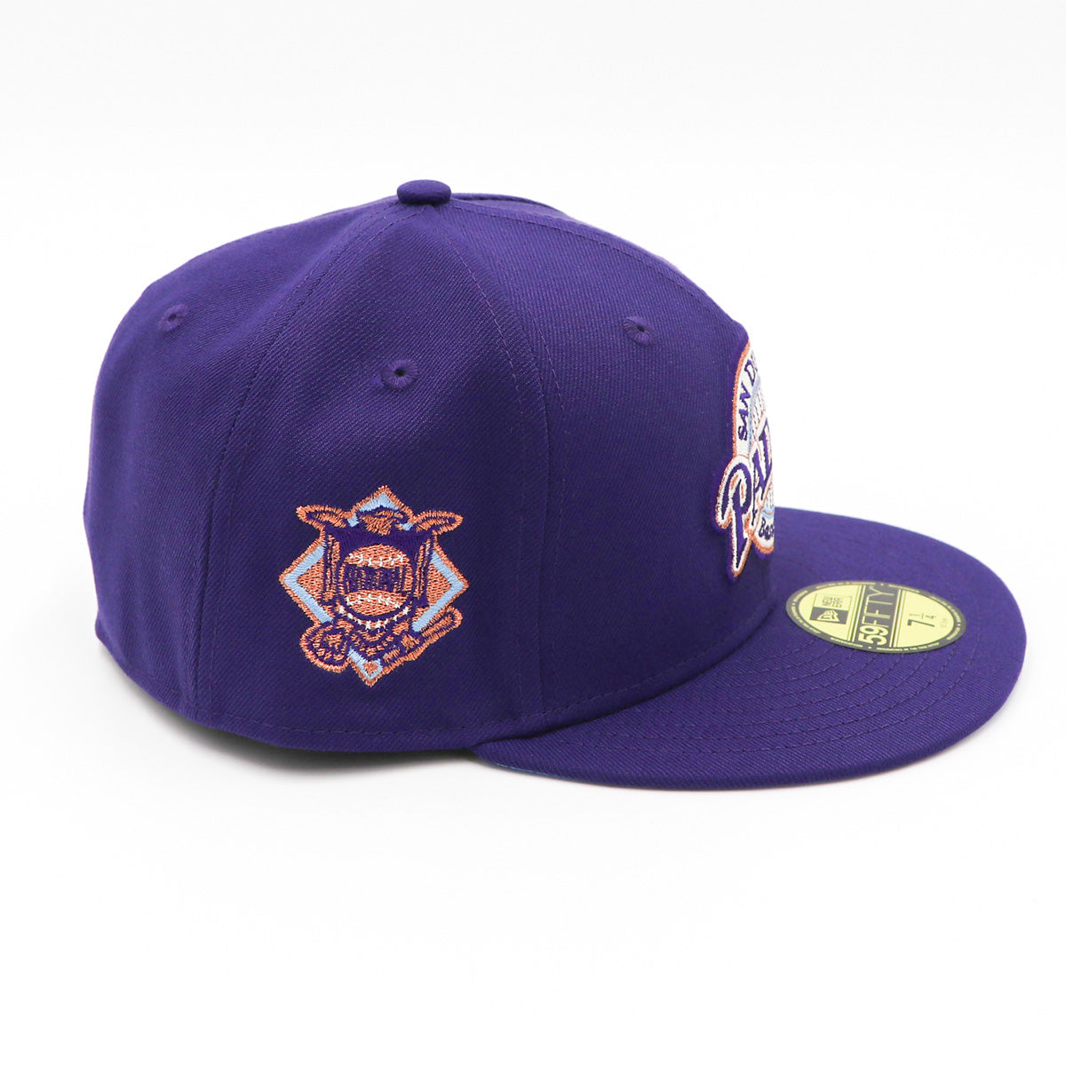 A purple fitted hat with metallic patches featuring the San Diego Padres logo.