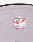 Baseball on a gray cap with visible stitching details