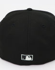 Black baseball cap with a logo on the back against a white background